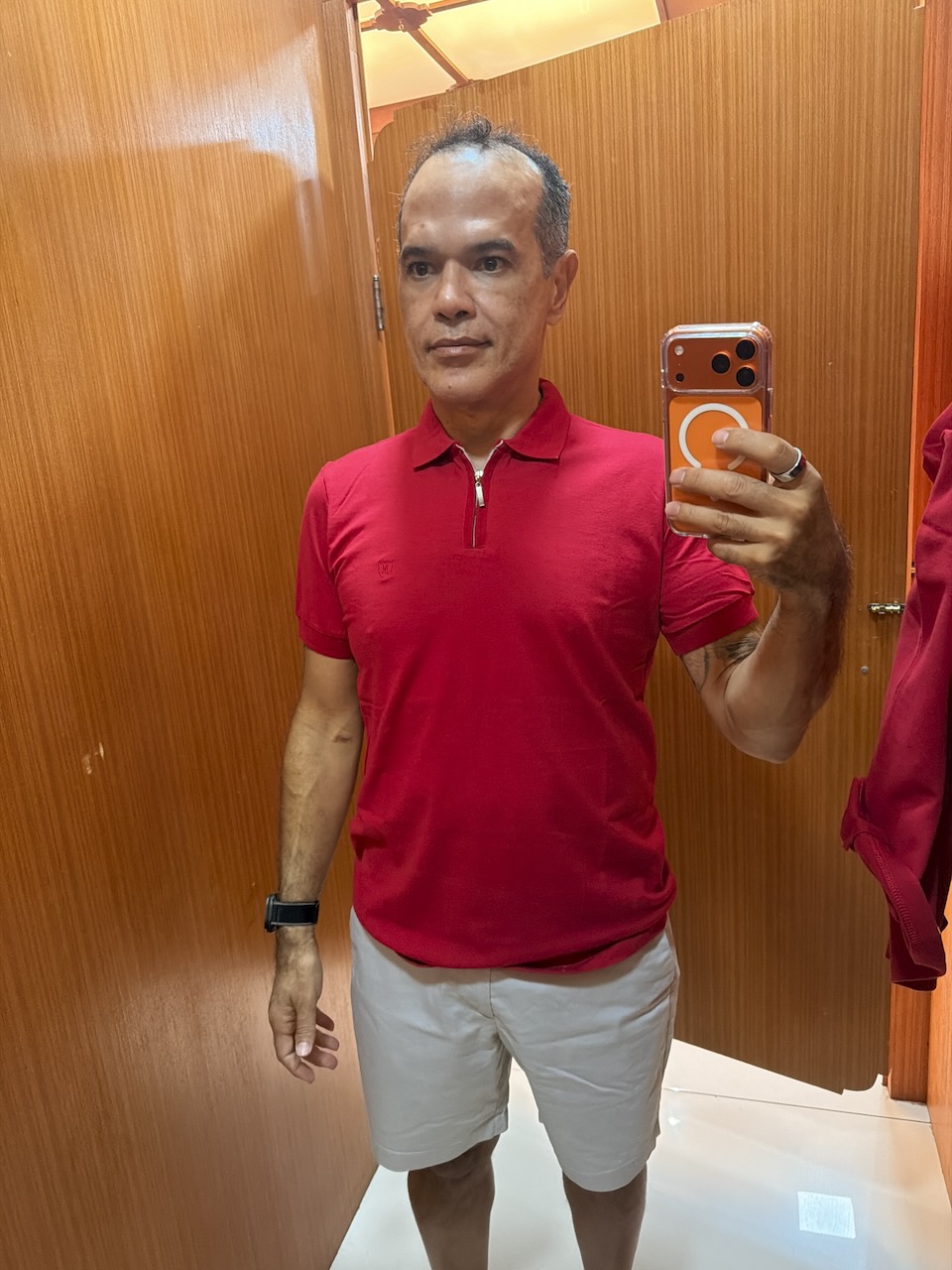 Saulo in a dressing room, red polo