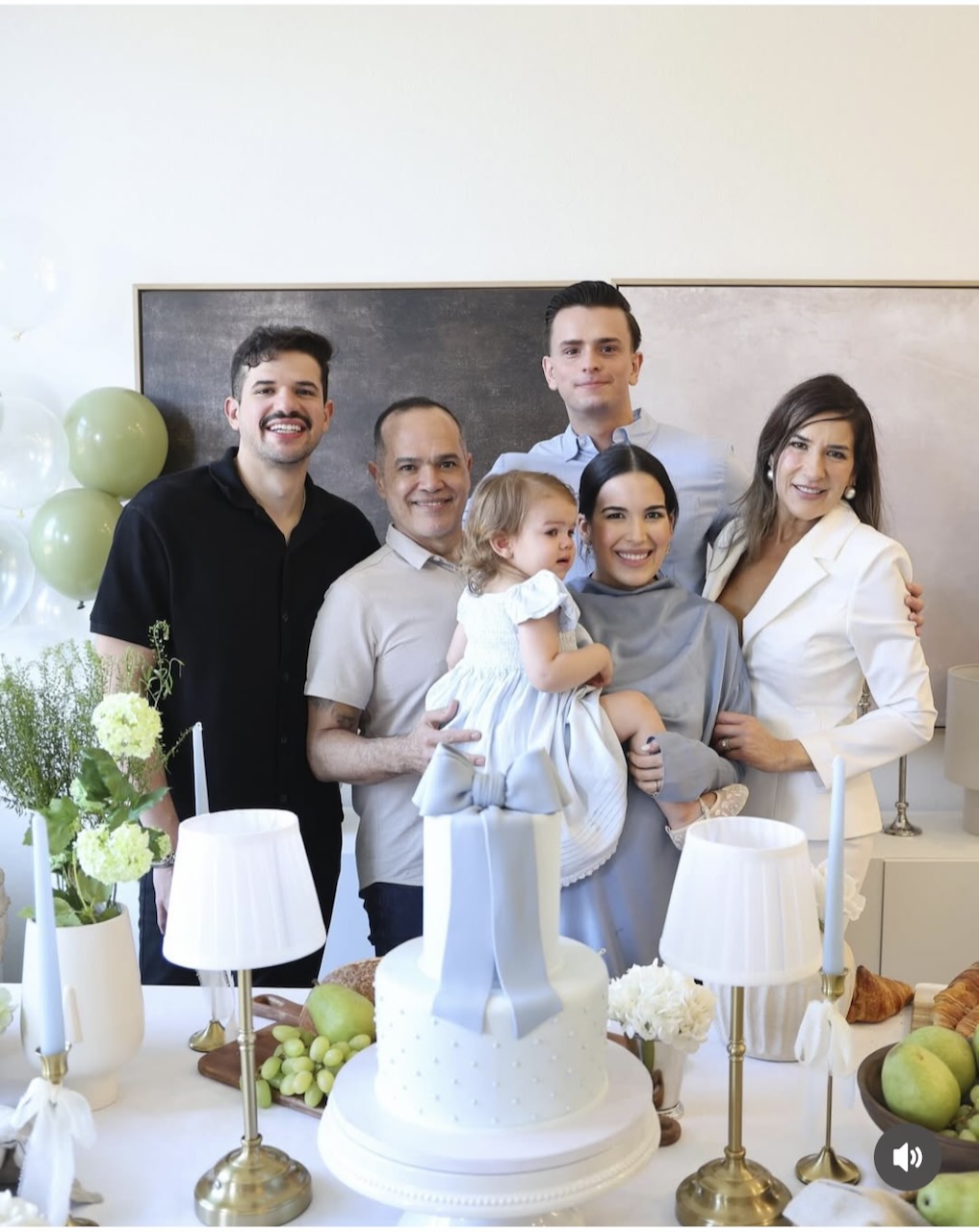 The Cruz family — Felipe, Saulo, Nathalia's husband, Nathalia holding Emma, and family at a celebration