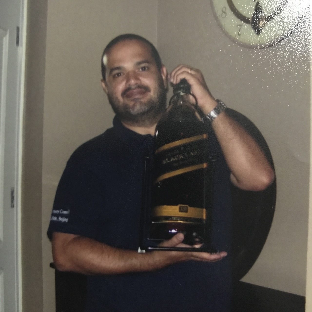 Saulo circa 2008 holding a large whiskey bottle